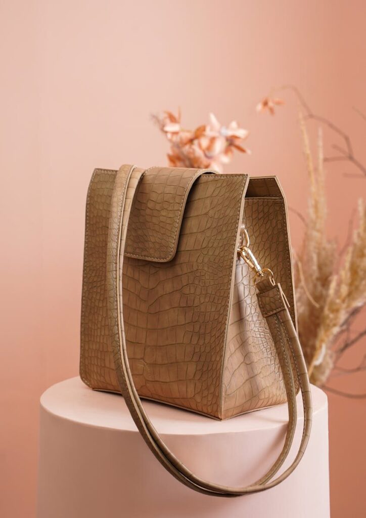 Stylish handbag with crocodile pattern design on elegant retail display.